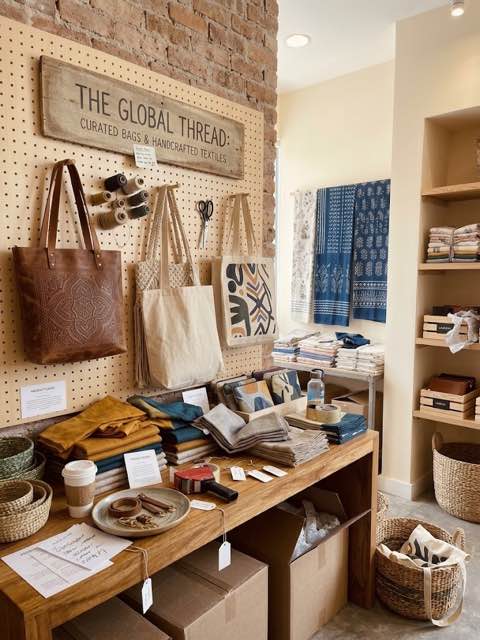 Hand-tooled leather totes and woven canvas bags on display